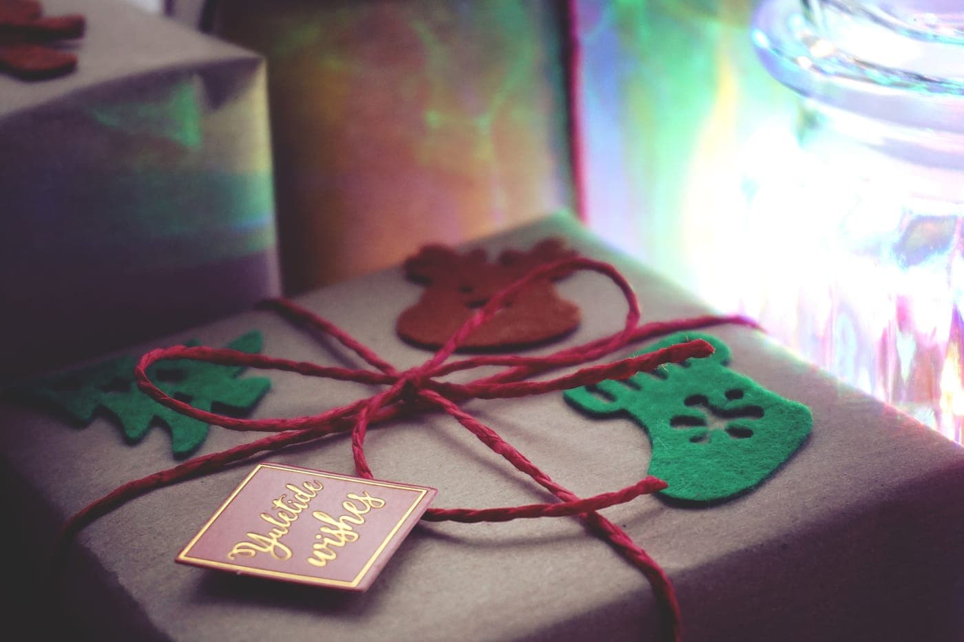 Wrapped holiday presents under warm indoor lighting