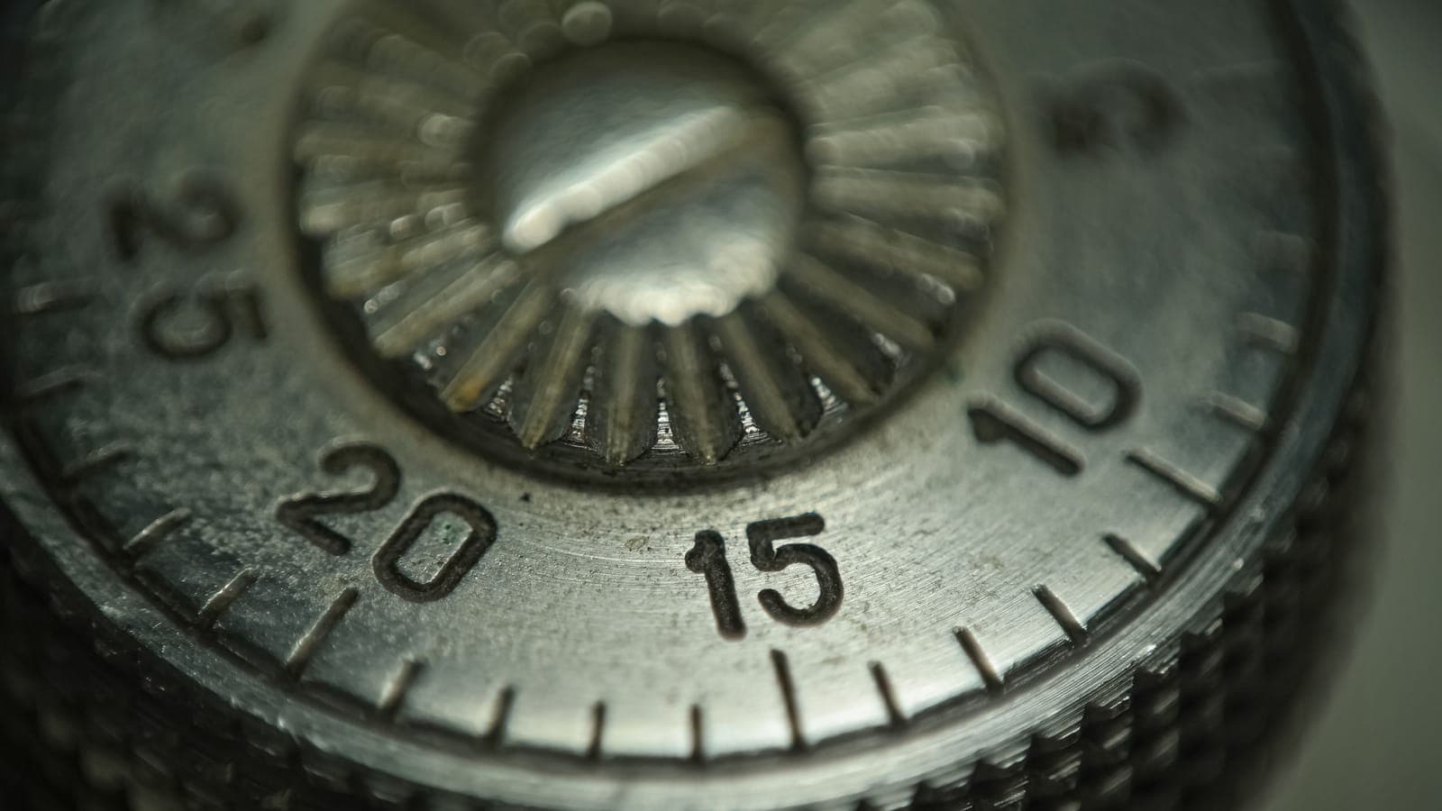 Macro shot of a metal combination dial and its numbered ring